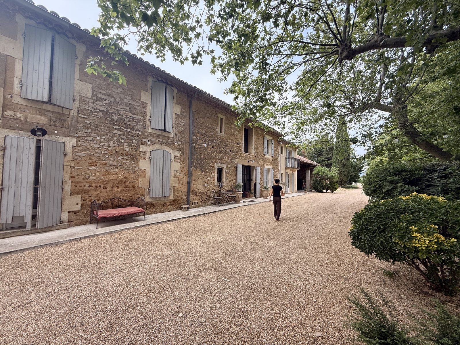 The gravel drive alongside the long stone farmhouse at Mouriès