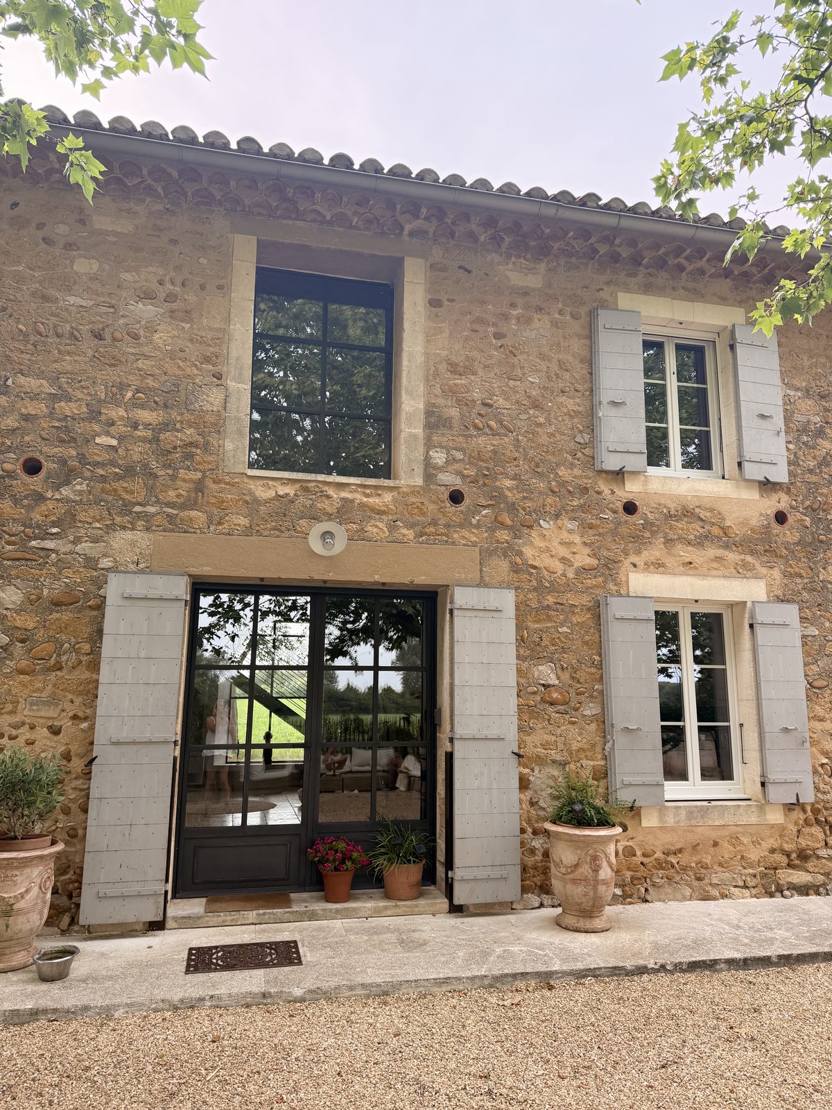 The stone farmhouse at Mouriès, shutters open, in late afternoon light