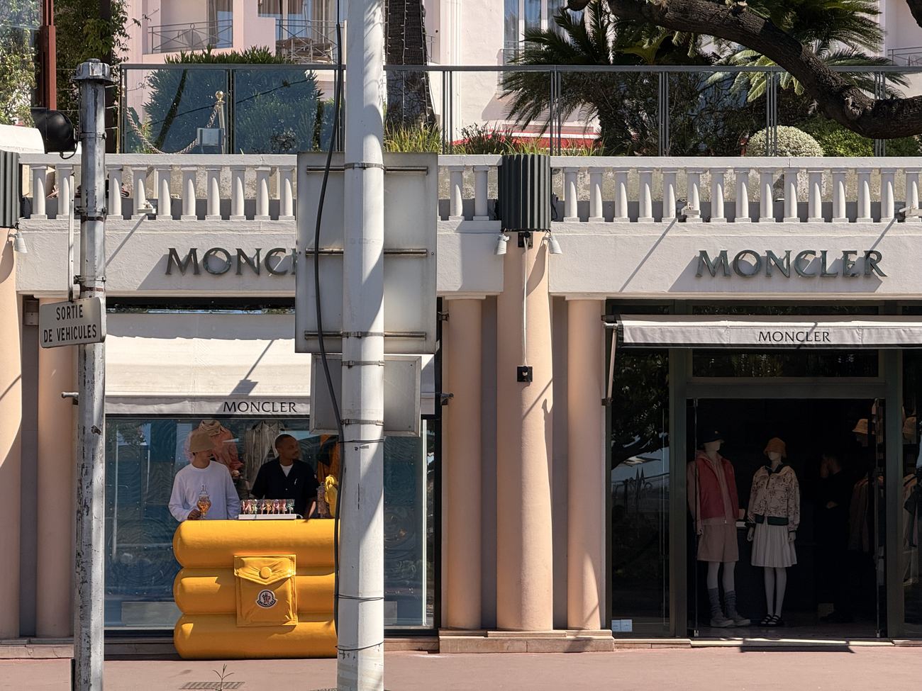 A luxury shopping street in Cannes, clean lettering above the windows