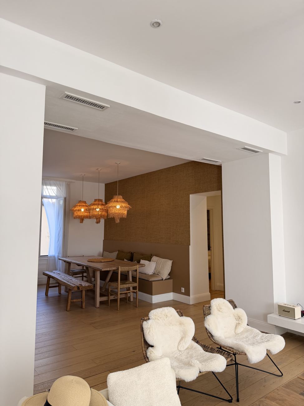 The bright, pale interior of the Cannes apartment with white sofas and big windows