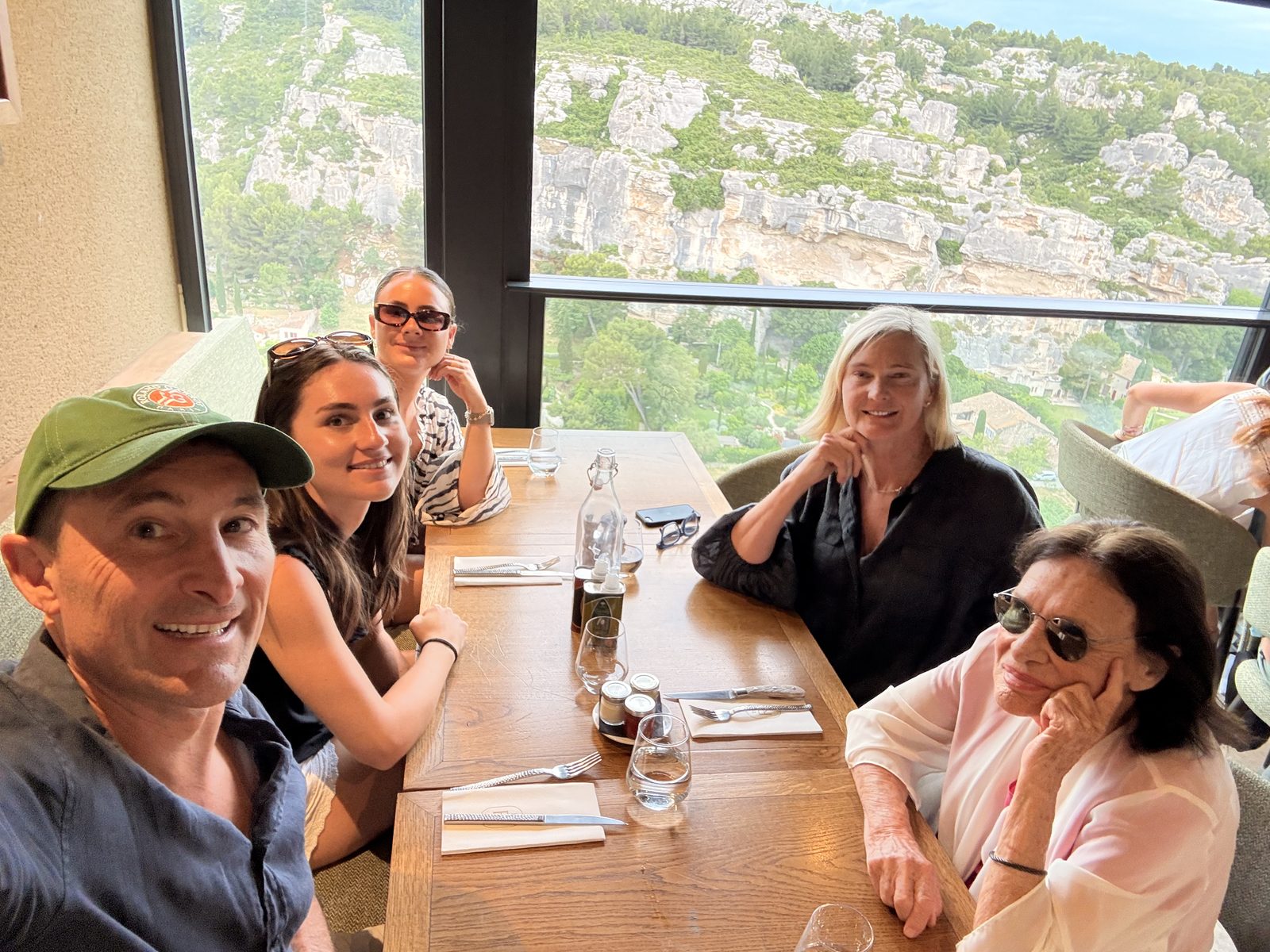 Five of the family at a restaurant table with a window looking out over the valley
