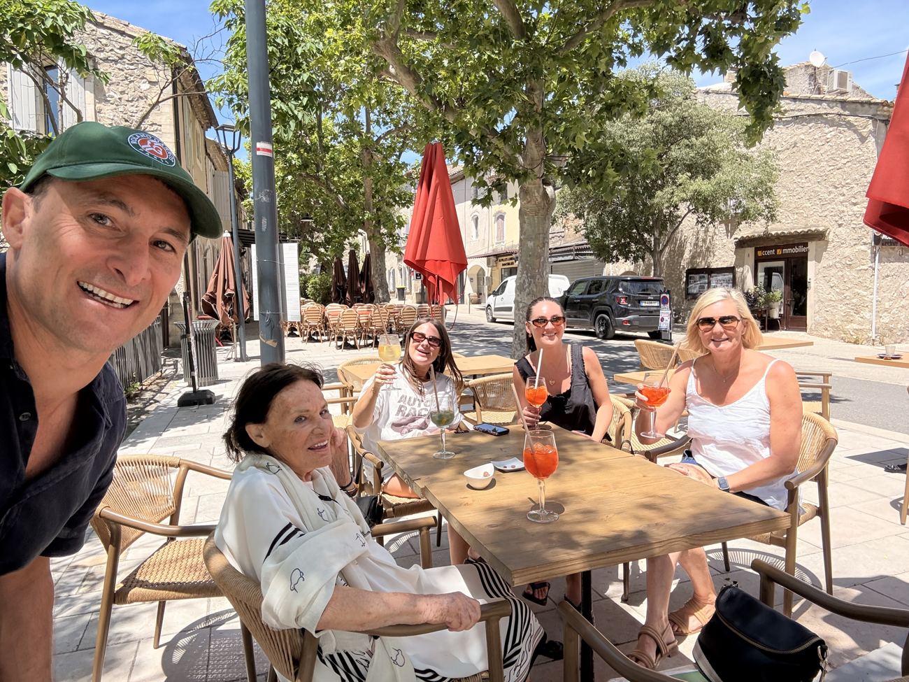 The family at a restaurant table with the Alpilles framed in a large window