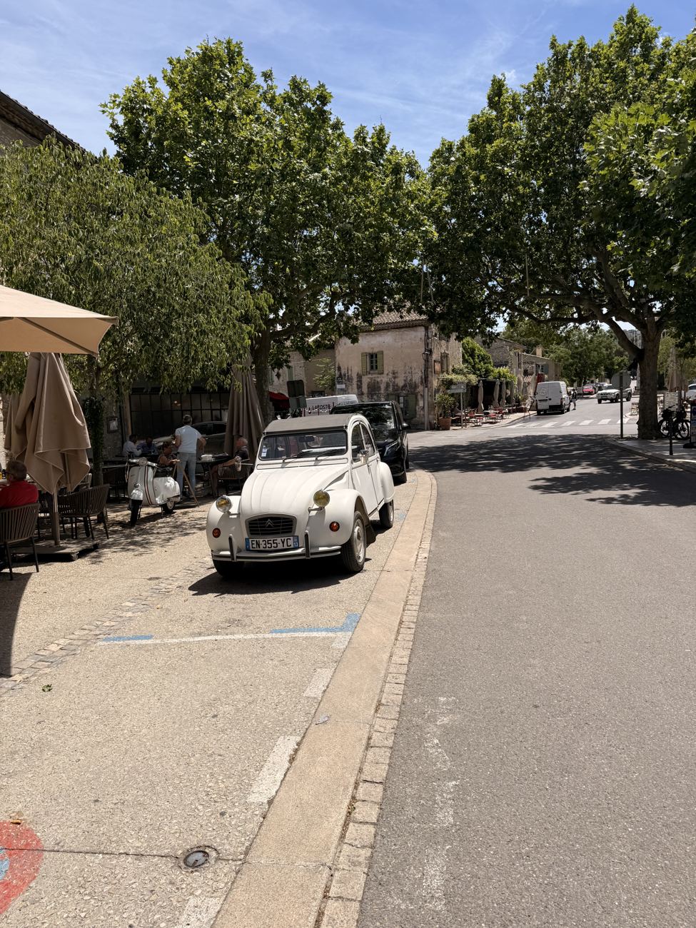 The family around a café table in the village square with aperitifs