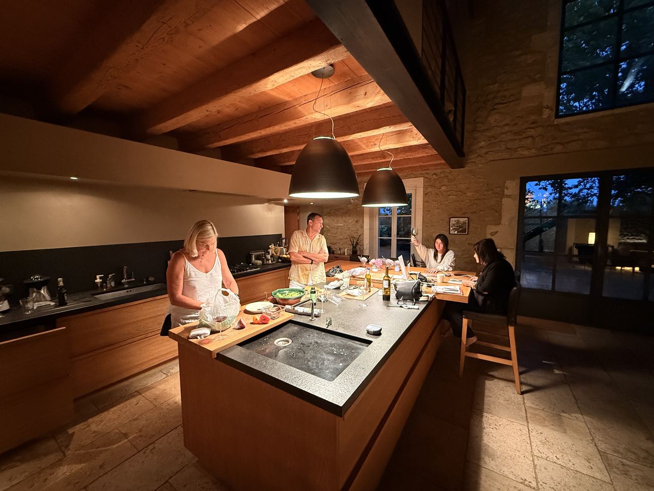 The kitchen at the mas on the last evening, two of the family cooking at the island