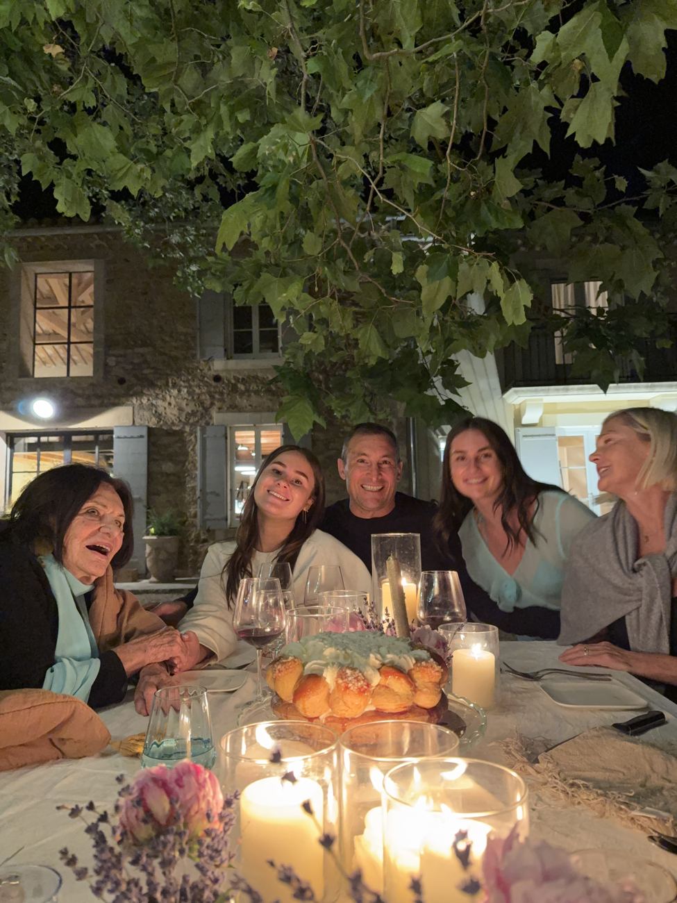 Women around the candlelit table laughing together