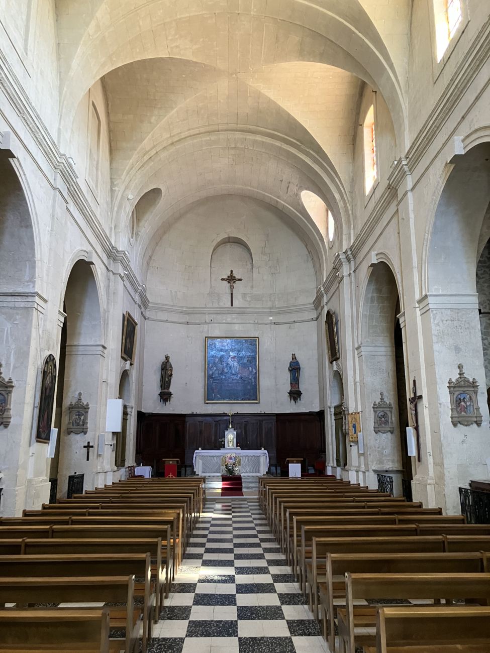 The cool interior of the village church at Lançon, a chequered floor running to the altar