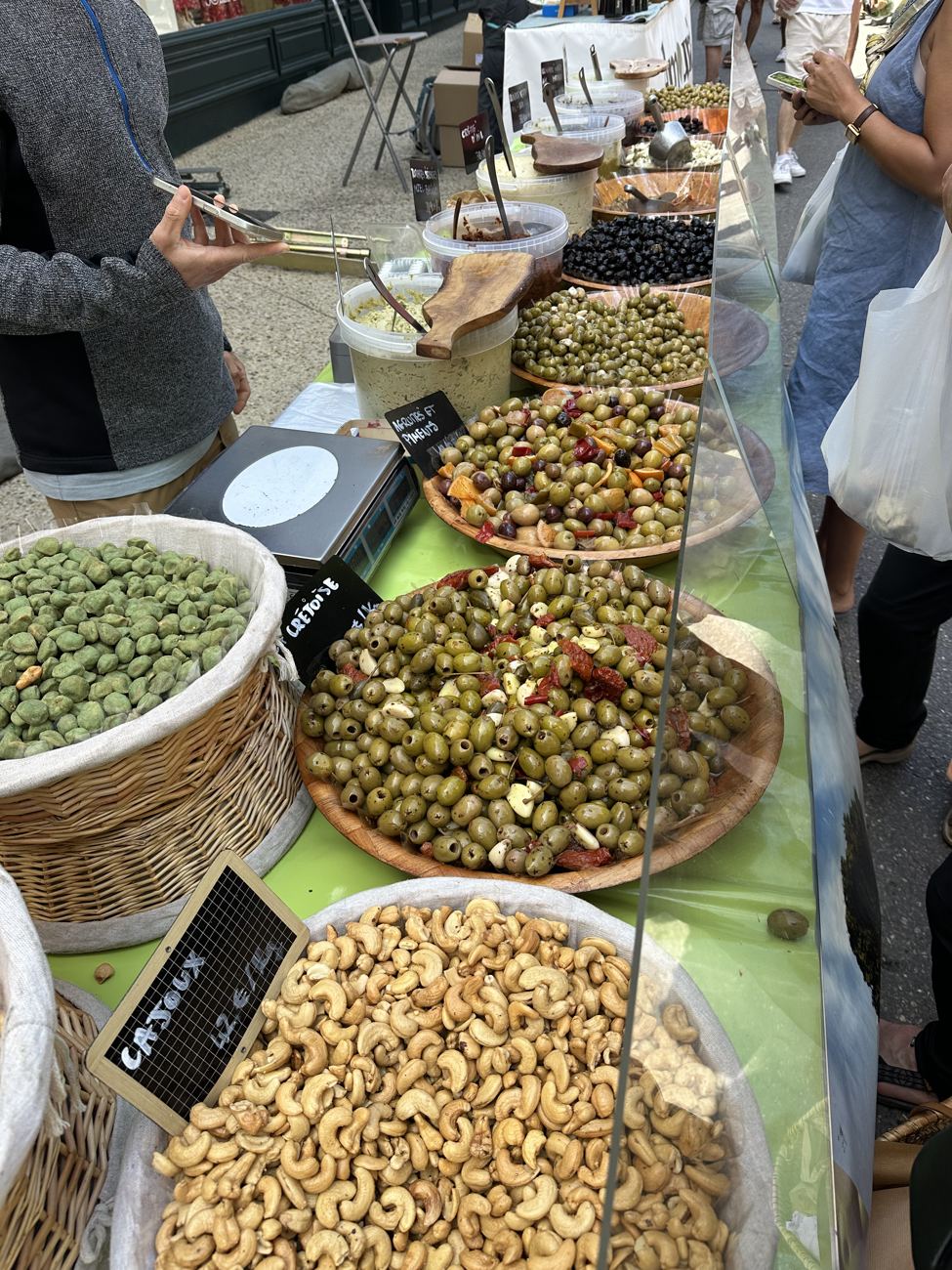 A Provençal market stall — baskets and bowls of olives, dried fruit, nuts and tapenades